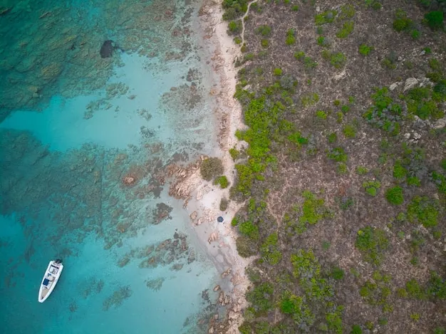 A small boat anchored off a reef-fringed shore, the kind of spot guided snorkelling uses.