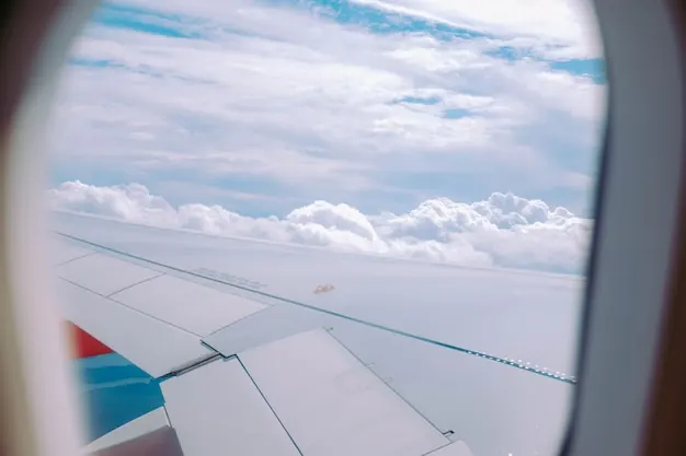 Clouds seen through an airliner window: we fix arrival times before the ground programme.