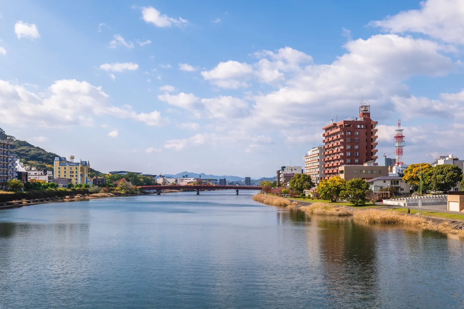 The Kagami River running through Kochi city between green banks and low hills.