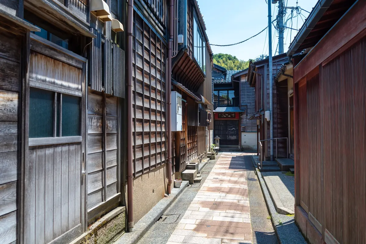 A quiet wooden lane in Kanazawa's teahouse district: Kanazawa remains the practical base for a Noto programme.
