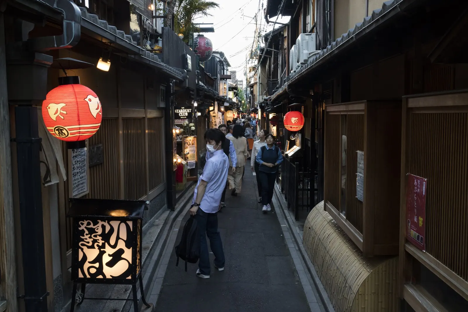 A narrow lane of restaurants in Kyoto's Pontocho district: many evening venues are a short walk from rail stations.