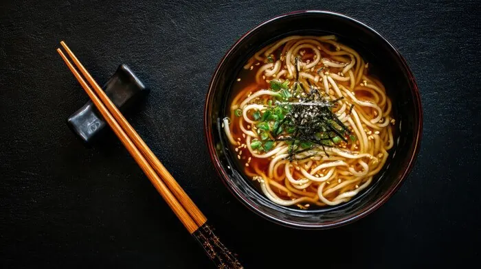 A bowl of wheat noodles in broth: in Kagawa a bowl like this is lunch, and making one is the group's activity.