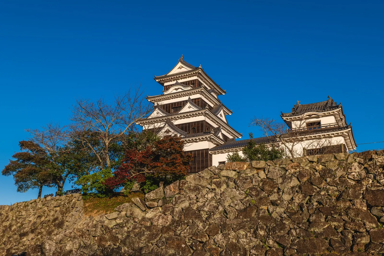 A wooden castle keep against the sky: Ozu Castle, rebuilt in wood, makes a strong half-day from Matsuyama.