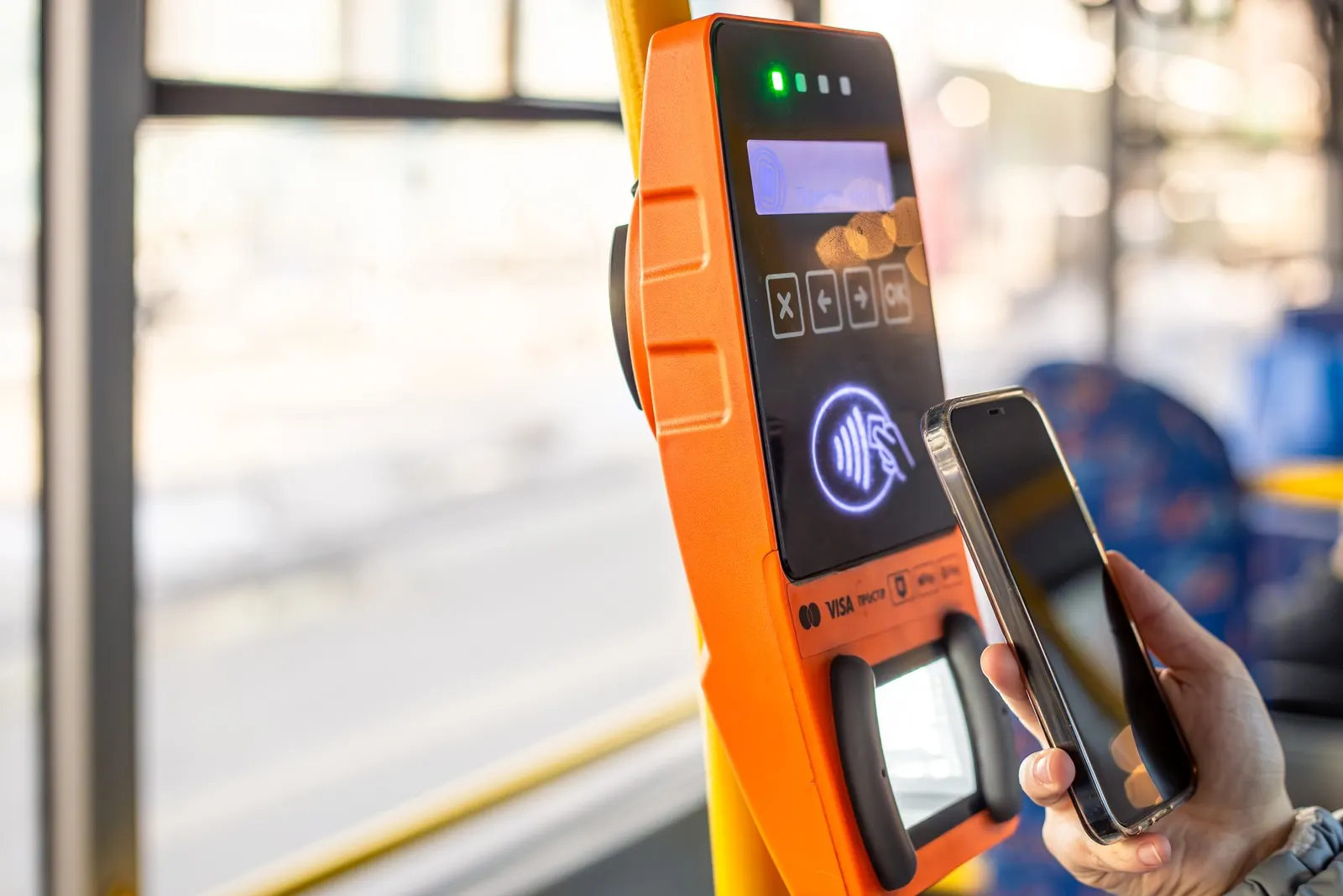 A phone held against a contactless fare reader.