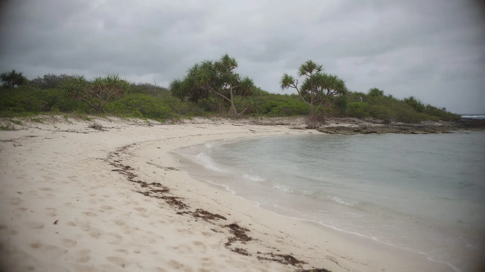 A quiet beach under grey cloud: Yaeyama is reef and island life more than resort pools.